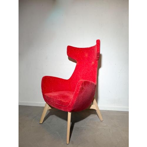 Make a bold statement with this striking high back lounge chair, upholstered in a vivid red velvet fabric with an elegant...