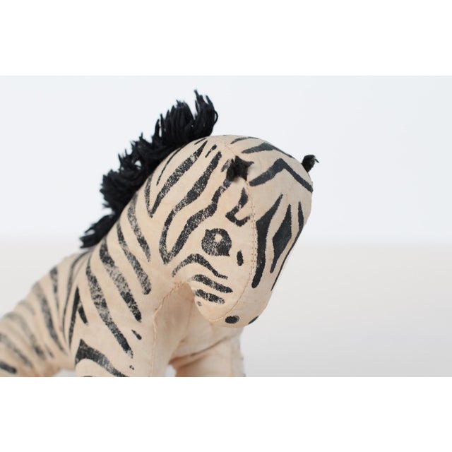 Vintage mid-century handmade stuffed zebra in cream cotton with hand-painted black stripes and a black yarn mane and tail....