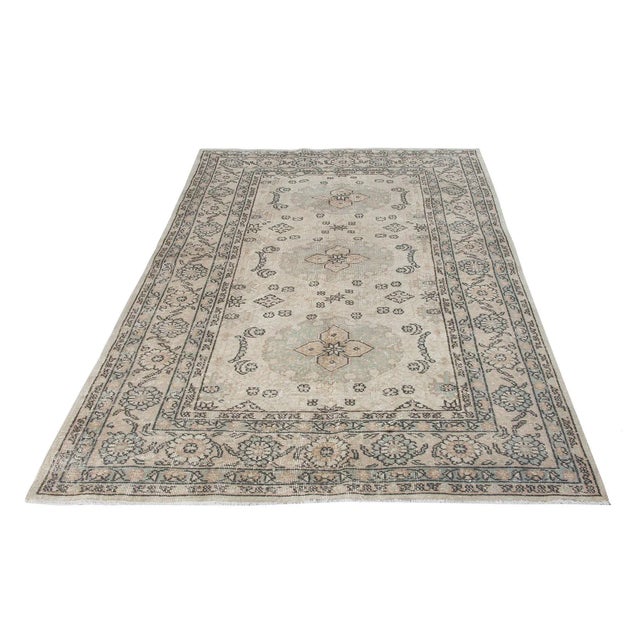 Decorative washed out handknotted vintage rug from Oushak region of Turkey. Approximately 50-60 years old. In very good...