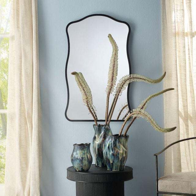 Step away from the square and infuse your home with character using this curvy wall mirror. Its vertical orientation and...