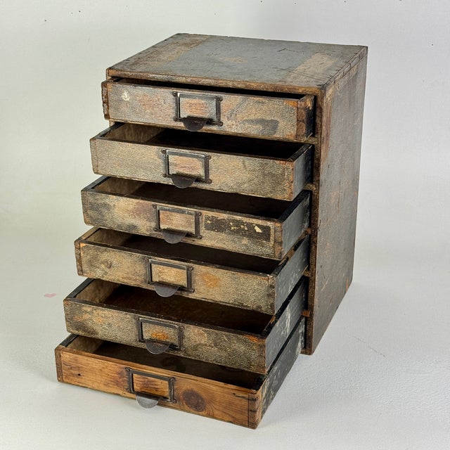 Magnificent office desktop multi drawer cabinet that was sourced in England. Remnant embossed patterned paper cover the...