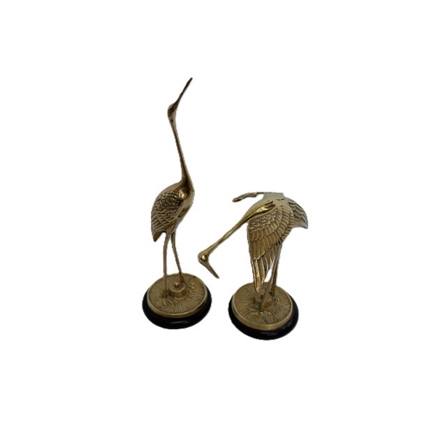 Fabulous and often hard to find pair of solid brass cranes featuring a polished gold finish with a natural patina...