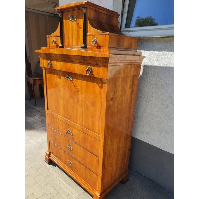 Impressive cherrywood secretary desk with upper section, upper section with two drawers, a door in the center, below which...