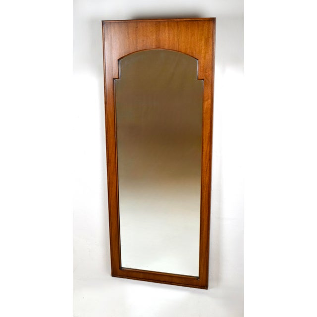 A scarcely seen pair of early 1950s John Stuart Inc. walnut mirrors. Suitable for placement in various interior settings...