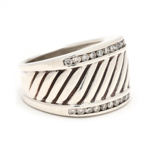 Stones: diamond, 24 round brilliant cut 1.75 mm approximately .50 total carats GH color/ SI1-2 clarity Ring Size 7 Width:...