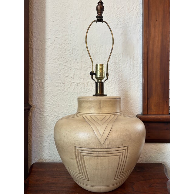 Handsome midcentury southwestern table lamp with contemporary linen shade. Lamp base plus finial measures 13.5"W x 26"H....
