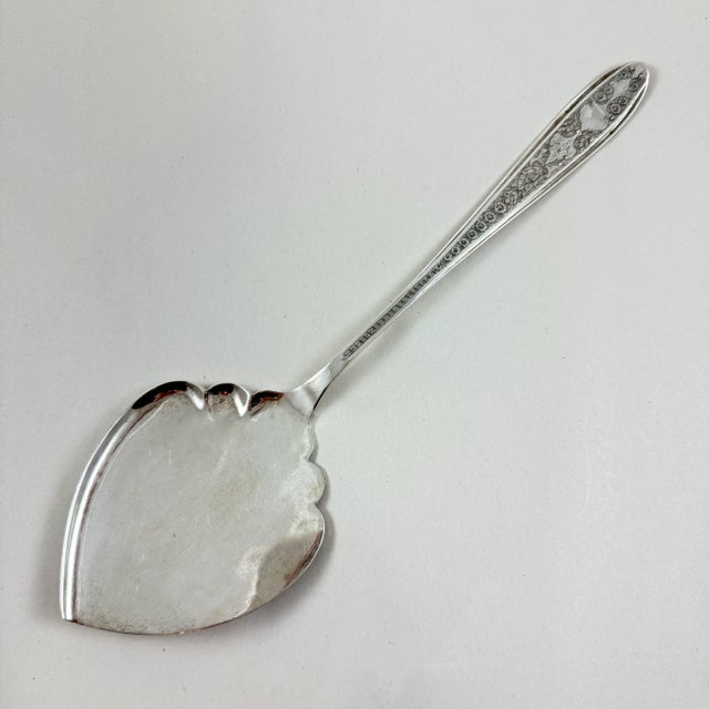 A marvelous estate find, a heavy, hand-made, silver pastry server, circa early 20th century. The server is a large and...