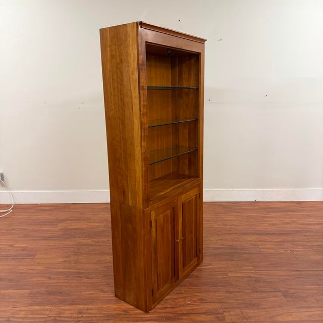 Vintage cherry display cabinet with hidden storage at the bottom and open shelves at the top. There are three removable or...