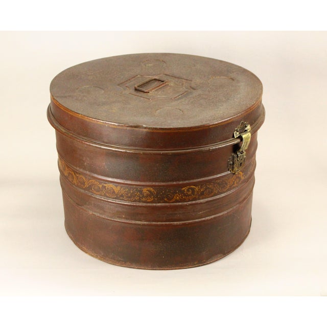 An outstanding antique hat box Circular metal container with unusual extra-large size Painted tin tole work with...