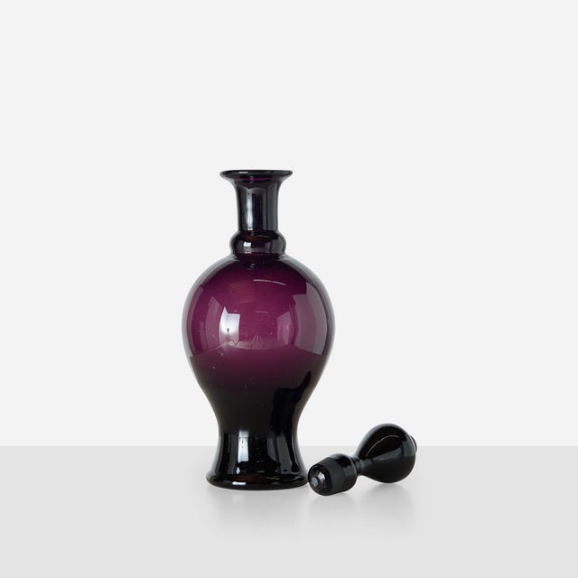 Description Amethyst Glass Decanter Denmark, Mid-20th Century Baluster-form amethyst glass decanter with tall, elongated...