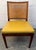 Set of six Mid-Century Modern walnut dining chairs featuring woven cane backrests and vibrant yellow vinyl upholstered...