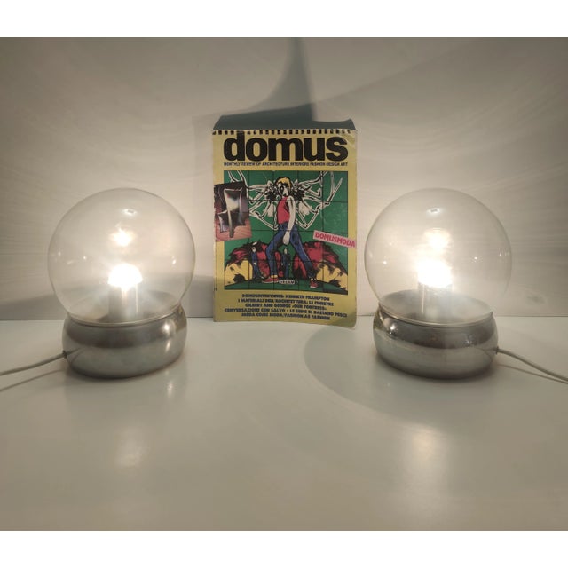 Made in Italy, 1970s. They feature a chrome-plated metal and aluminum structure with glass lampshades. These table lamps...