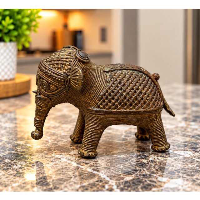 Beautiful vintage brass elephant figurine featuring exceptionally intricate detailing throughout. The body is covered in...