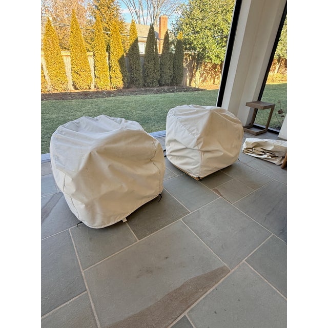 Pair of RH Oslo Swivel Outdoor Lounge Chairs The Oslo outdoor chair was inspired by mid-century design. It is curvaceous...