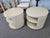 Postmodern rotating drum-style end tables by Saladino. Cream lacquer finish, circular layered shelves, and swivel design.