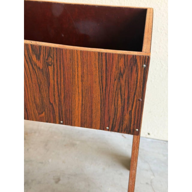 This sculptural vintage Danish planter stand is crafted in richly grained rosewood and showcases bold Mid Century Modern...
