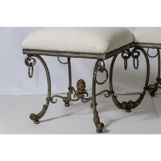 This is a very unusual Italian Silver and Gilt Wrought Iron Scrolled Base Double Stool with new upholstery in French White...