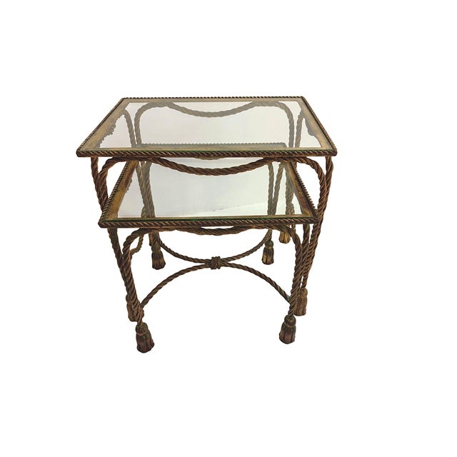 Gilt Hollywood Regency Rope and Tassel Nesting Tables - Set of Two A pair of nesting tables that announce themselves...