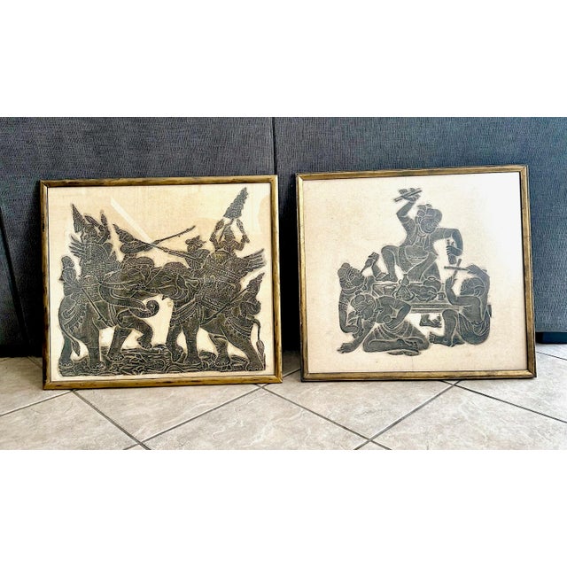 Pair vintage framed temple relief rubbings showcases exquisite Thai art from the mid-century era. Handmade in Thailand,...