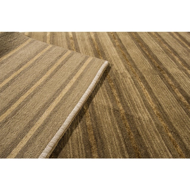 Beautiful modern Shakti hand-knotted wool runner with a brown field. This rug has a tan accent in an all-over geometric...
