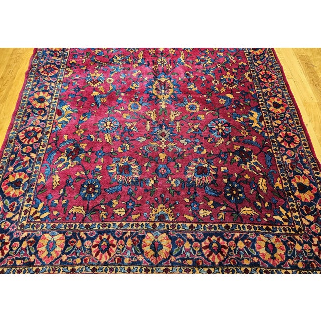 A very rare gallery-size Persian "Manchester" Kashan in an allover design set in a medium burgundy field color with a...