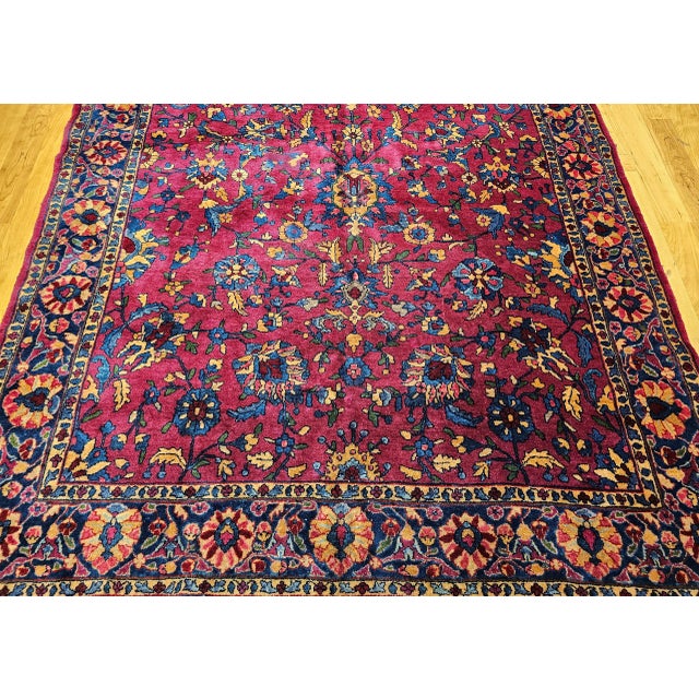 6’ 2" x 12' A very rare gallery-size Persian "Manchester" Kashan in an allover design set in a medium burgundy field color...
