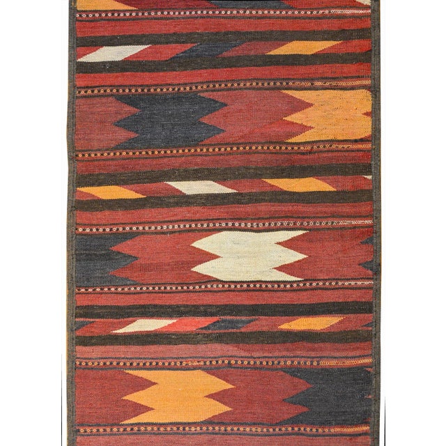 A striking vintage Afghani Baluchi runner with a wonderful bold pattern containing wide alternating zigzag stripes and...