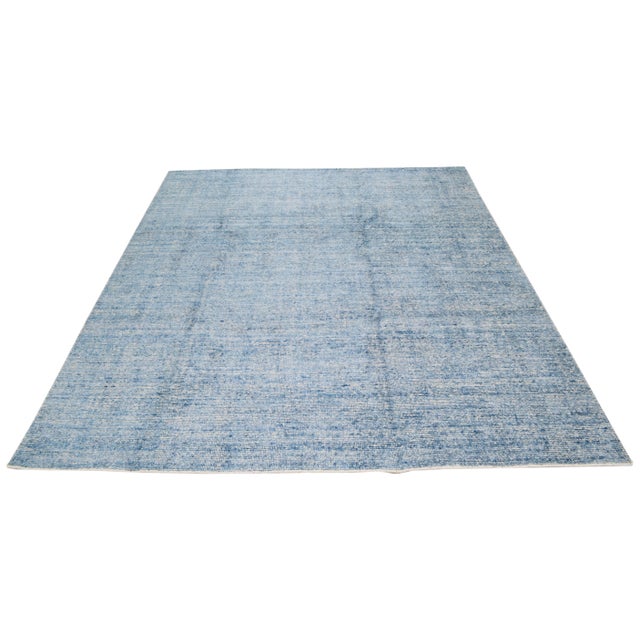 Modern hand loomed rug with natural colors, contemporary minimalist style and soft texture.