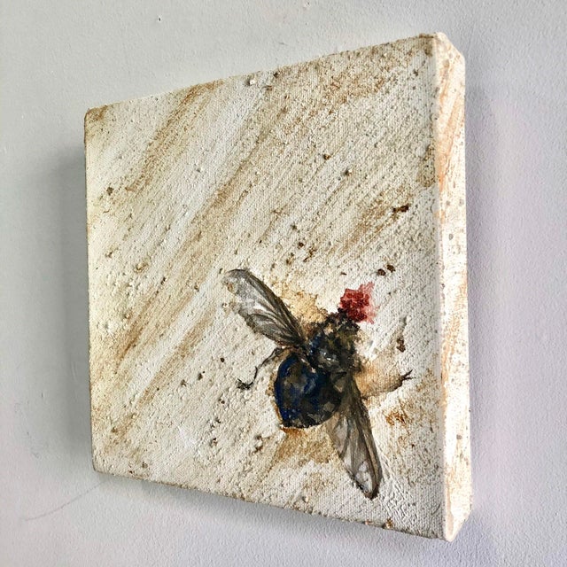 This artwork features a detailed depiction of a fly, rendered in ink and acrylic, with a striking contrast between the...