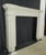 Victorian style fireplace mantel with a thick layer of white paint. It features raised beads, urns, floral, torches, and...