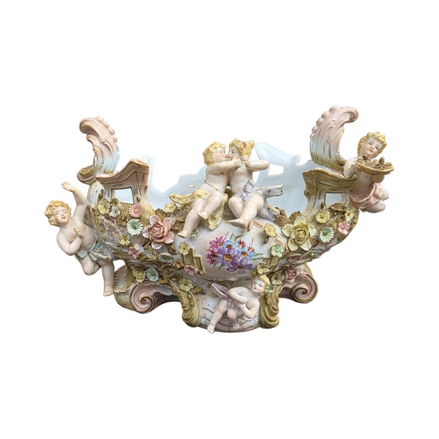 Exuberant Dresden-style porcelain centerpiece or jardiniere featuring romantic putti figures, elaborate applied floral...