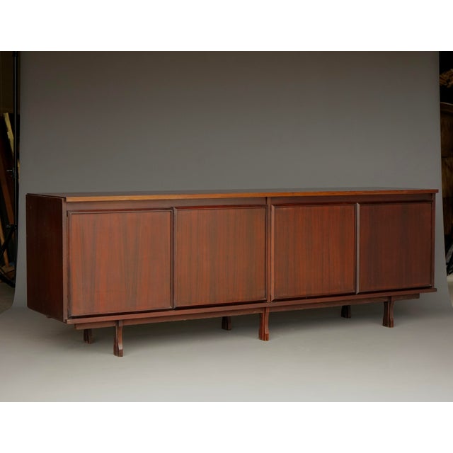 Rare high-quality sideboard/credenza, Italian design from the 1960s. It has four hinged doors and, inside, a large...