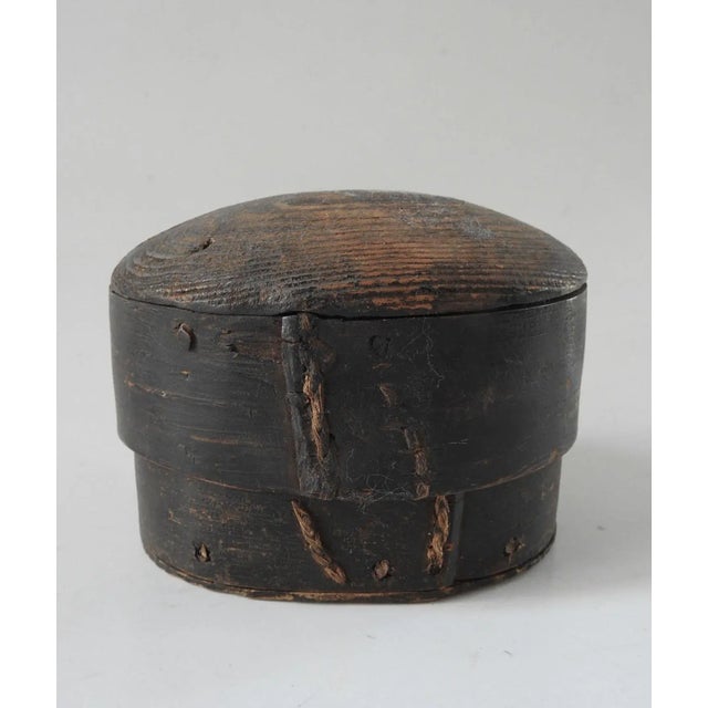 Small oval bentwood box with domed lid. Hand made, stitched and pegged construction. No markings, overall wear, darkening...