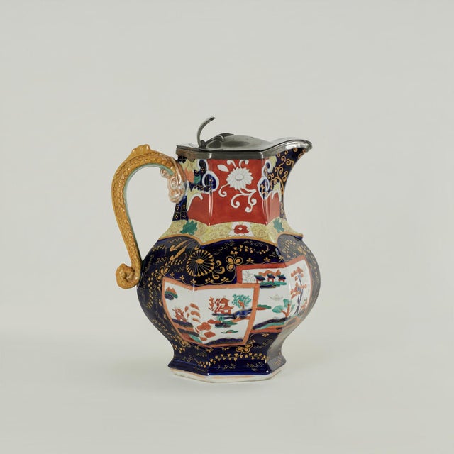 Standout 19th century English ironstone pitcher featuring a pewter lid on a ewer hand decorated in a colorful Imari style...