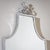 Wall mirror with a simple polished steel frame. The frame rises at the top and is crowned by an ornamental Art Deco crest.