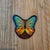 A sophisticated 12-piece assembly of motorcycle rally artifacts, headlined by the colorful 2009 Sturgis Butterfly and a...