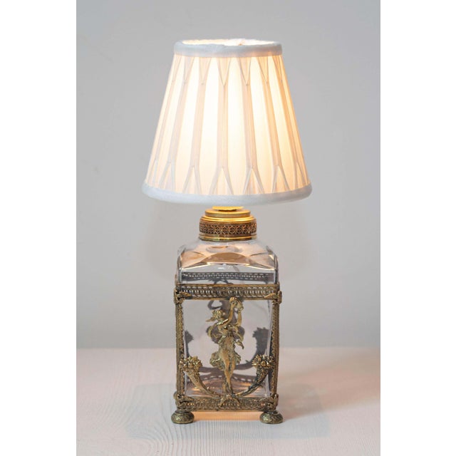 This exquisite 19th-century French lamp showcases exceptional craftsmanship and artistic elegance. The lamp features a...