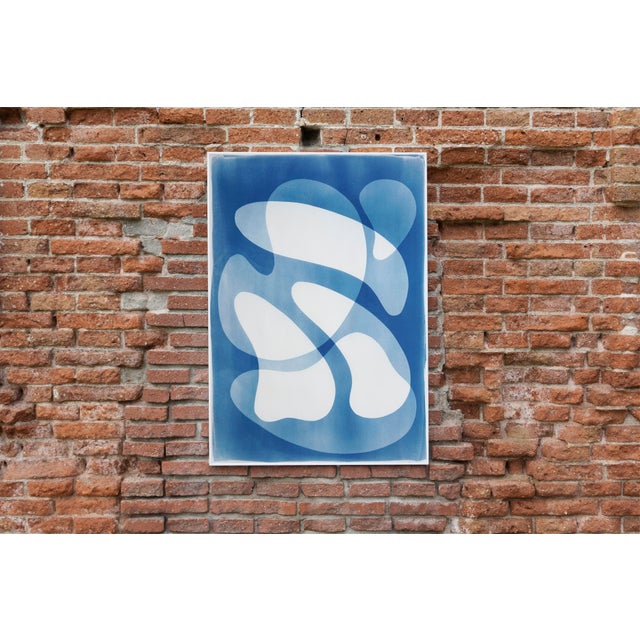 Rotating Mobile is a captivating cyanotype monotype that draws on the visual language of mid-century abstraction....