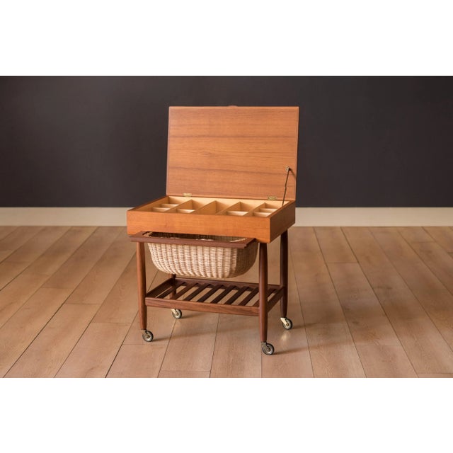 Mid century modern sewing end table in teak designed by Ejvind A. Johansson for FDB Mobler, Denmark. This two-tone piece...