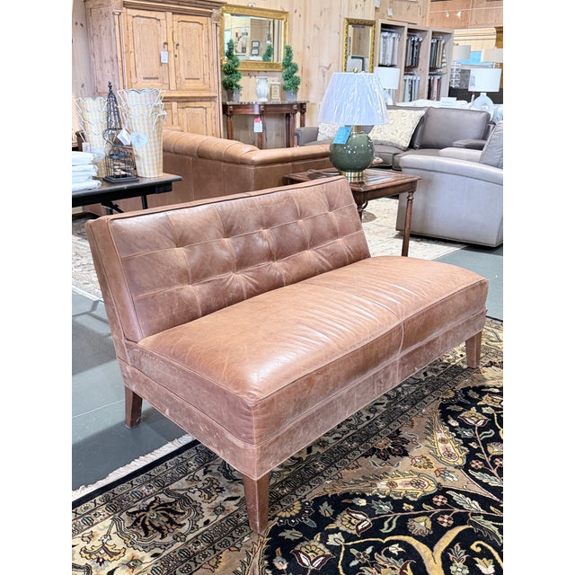 A sophisticated Mitchell Gold + Bob Williams leather bench settee that blends clean architectural lines with the warmth...