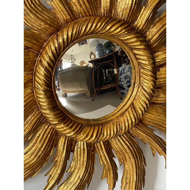 This is a striking French Sunburst hand carved giltwood mirror. The mirror is slightly convex. The gilding is of a...