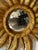 This is a striking French Sunburst hand carved giltwood mirror. The mirror is slightly convex. The gilding is of a...