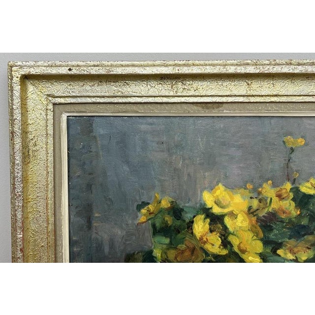A charming Vintage French signed oil painting depicting a still-life arrangement of vibrant yellow flowers and rich green...