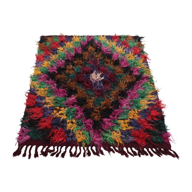 Coming from Turkey circa 1950-1960, this 4x5 vintage shag rug enjoys a resplendent high pile in magenta, forest green,...