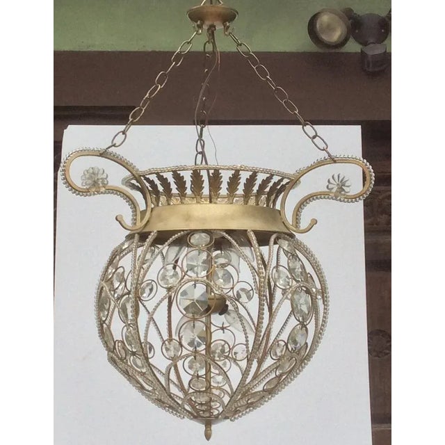 Vintage tole and crystal beaded ball and crown form hanging lantern from the late 20th century. This was a canopy and...
