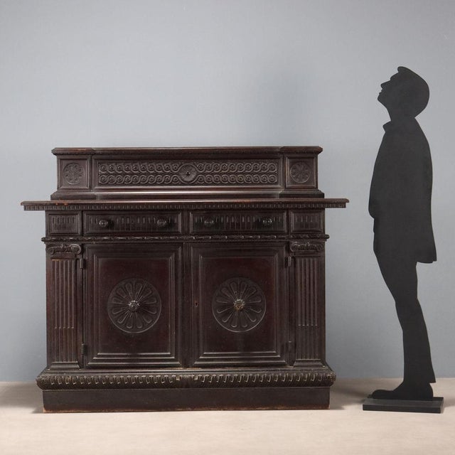 Neo-Renaissance-style sideboard in ebonized walnut. Front with a pair of drawers in the lower section and a pair of...