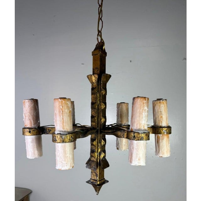 This six-light chandelier is a striking example of rustic, hand-forged craftsmanship with a bold, geometric silhouette....