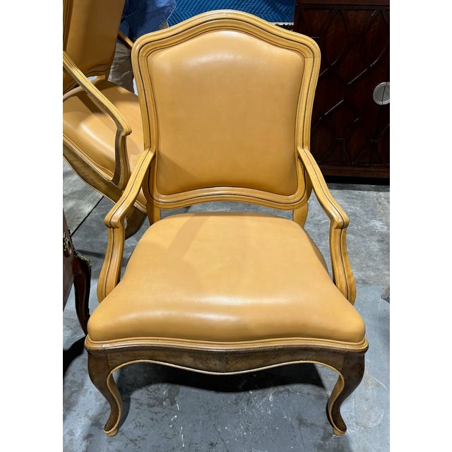 Pair of Louis XV style bergeres from William Switzer. These arm chairs have elegant, rounded backrests, molded wood...