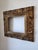 A high-quality antique baroque/rococo style frame carved from gold gilt wood. It features detailed design elements of...