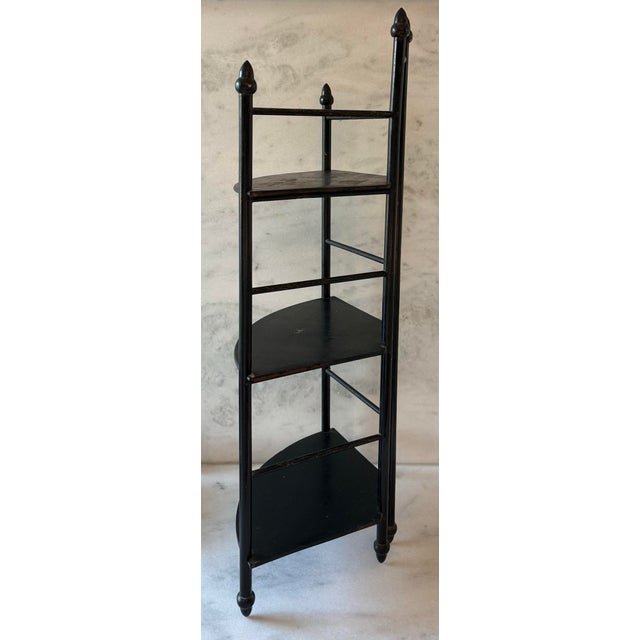 Vintage 3 shelf black wood etagere. Shelves have a nice curved front and acorn shaped detailes at the feet and top.